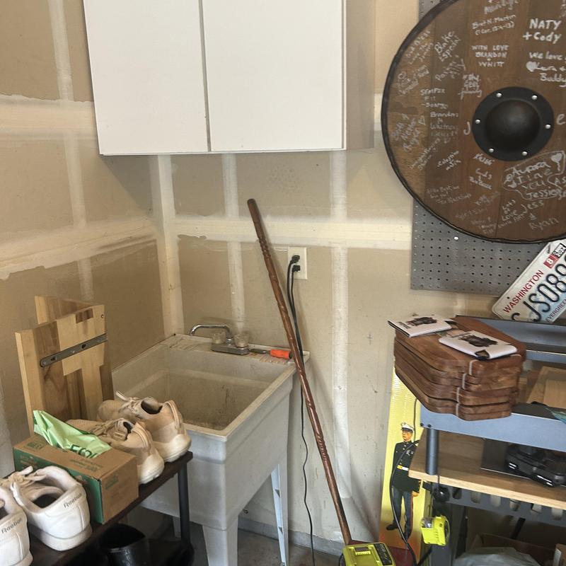 Utility sink in garage with shoes and tools Utility sink in garage with shoes and tools