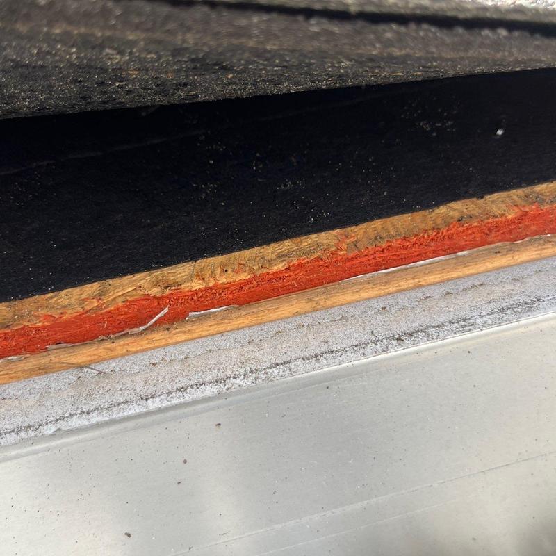 Roof shingle edge with hail damage and exposure defect