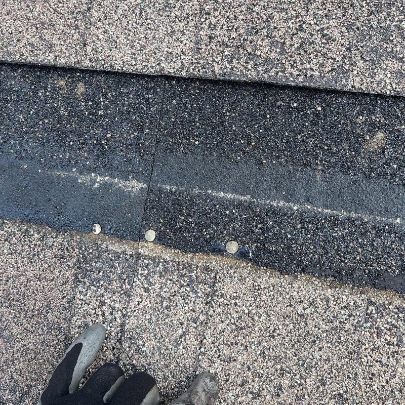 Asphalt roof shingles with hail damage and nails