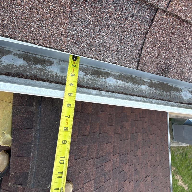 Roof gutter with tape measure measuring length