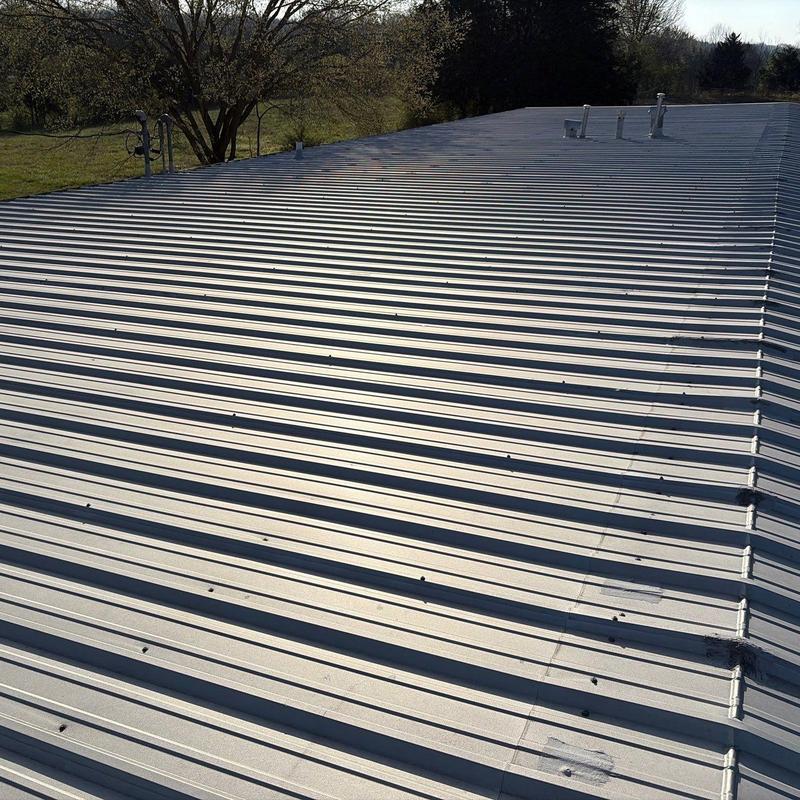 Metal commercial roof panels with minor hail damage