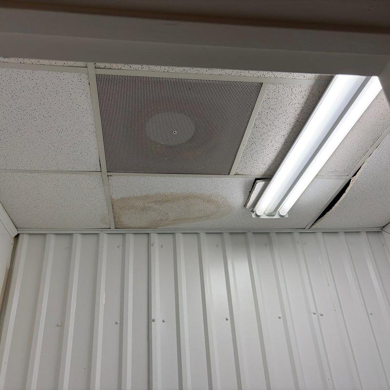 Ceiling tiles with water damage and fluorescent light