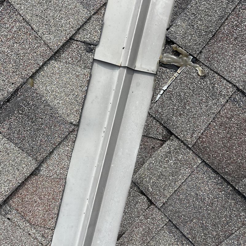 Roof valley flashing with cracked shingle and sealant repair Roof valley flashing with cracked shingle and sealant repair