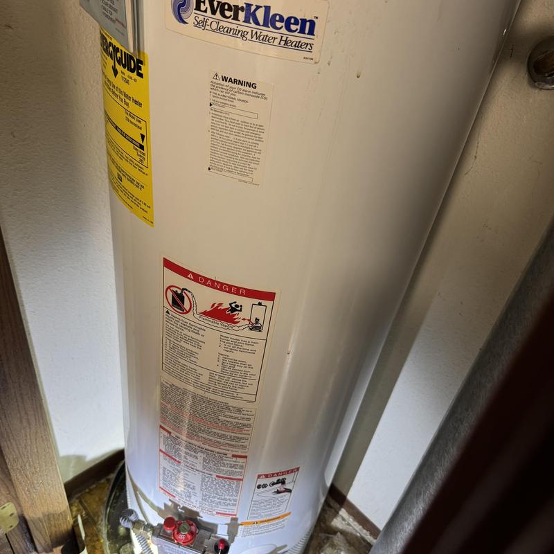 Gas water heater showing corrosion at base leak Gas water heater showing corrosion at base leak