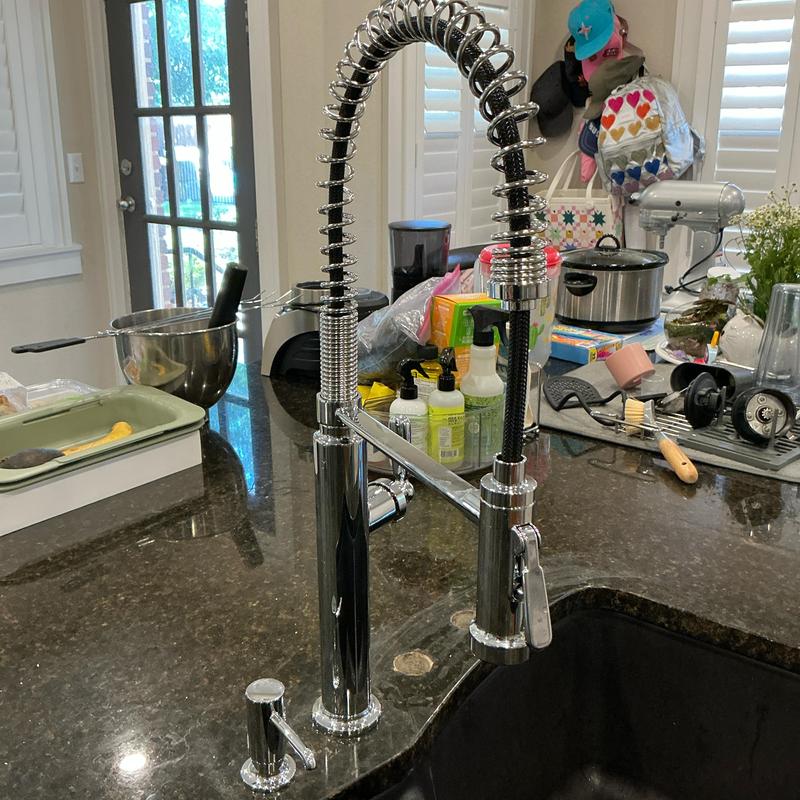 Kitchen faucet installation on dark granite countertop