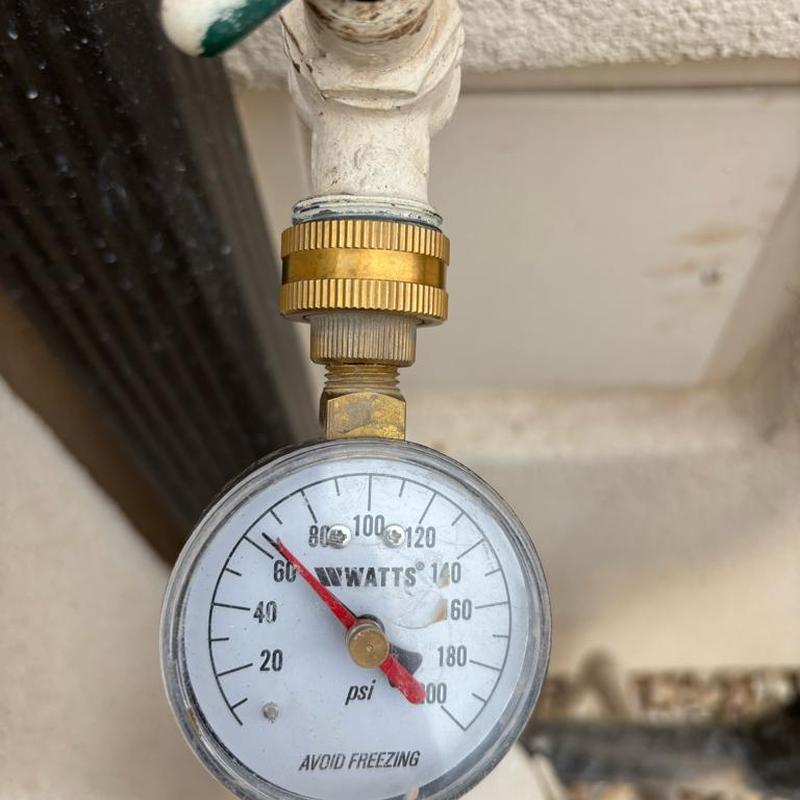 Pressure gauge on water valve showing 65 psi pressure Pressure gauge on water valve showing 65 psi pressure