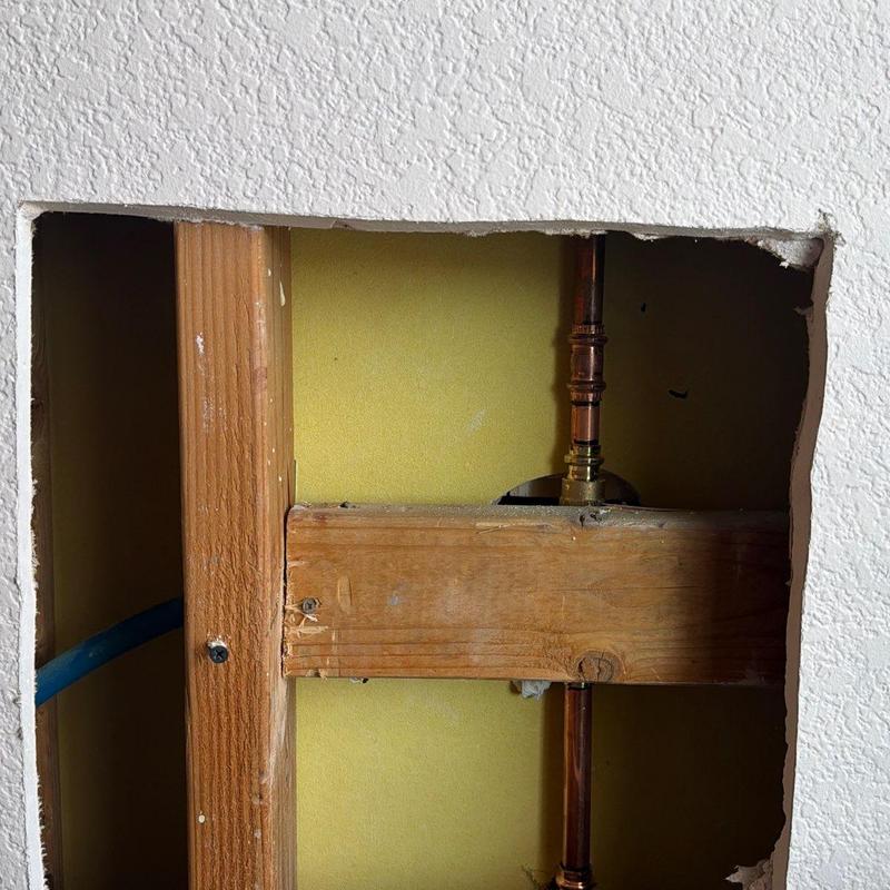 Shower valve and copper piping with access panel opening Shower valve and copper piping with access panel opening