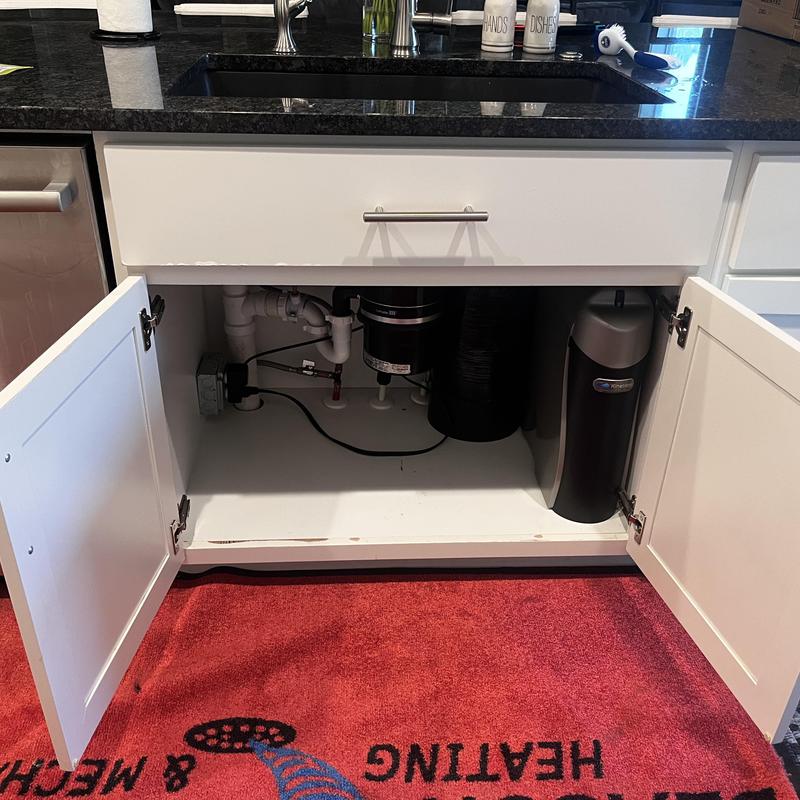 Water softener and garbage disposal under kitchen sink