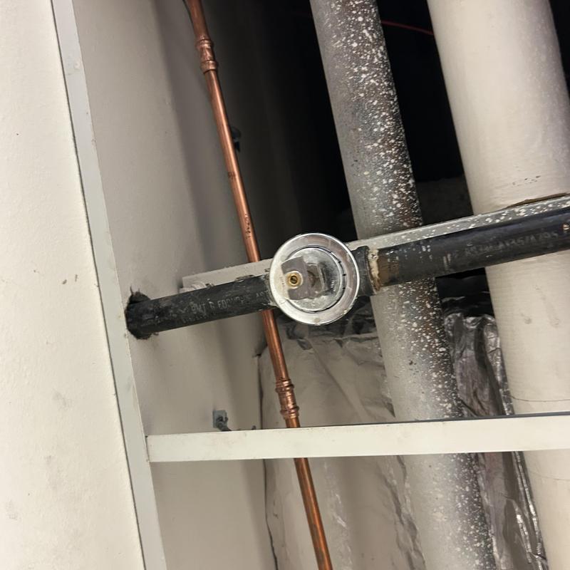 Black iron pipe with pressure gauge in drop ceiling Black iron pipe with pressure gauge in drop ceiling