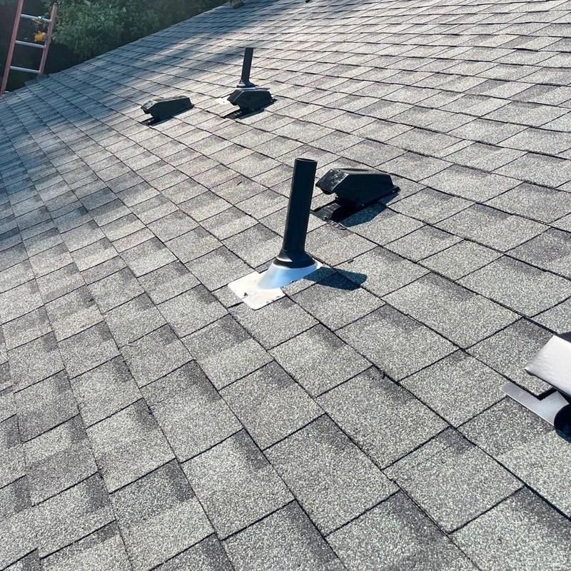 Asphalt shingle roof with vent pipes