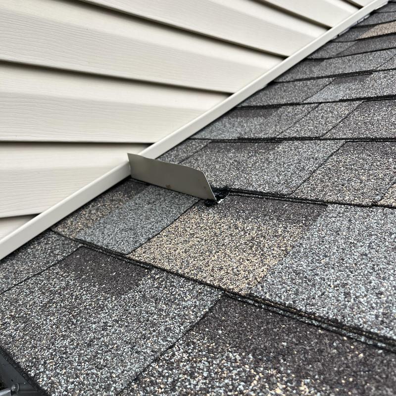 Roof shingle diverter installation near siding wall Roof shingle diverter installation near siding wall