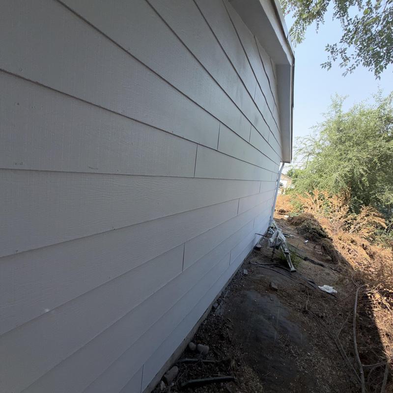 House exterior siding with dirt and debris nearby House exterior siding with dirt and debris nearby