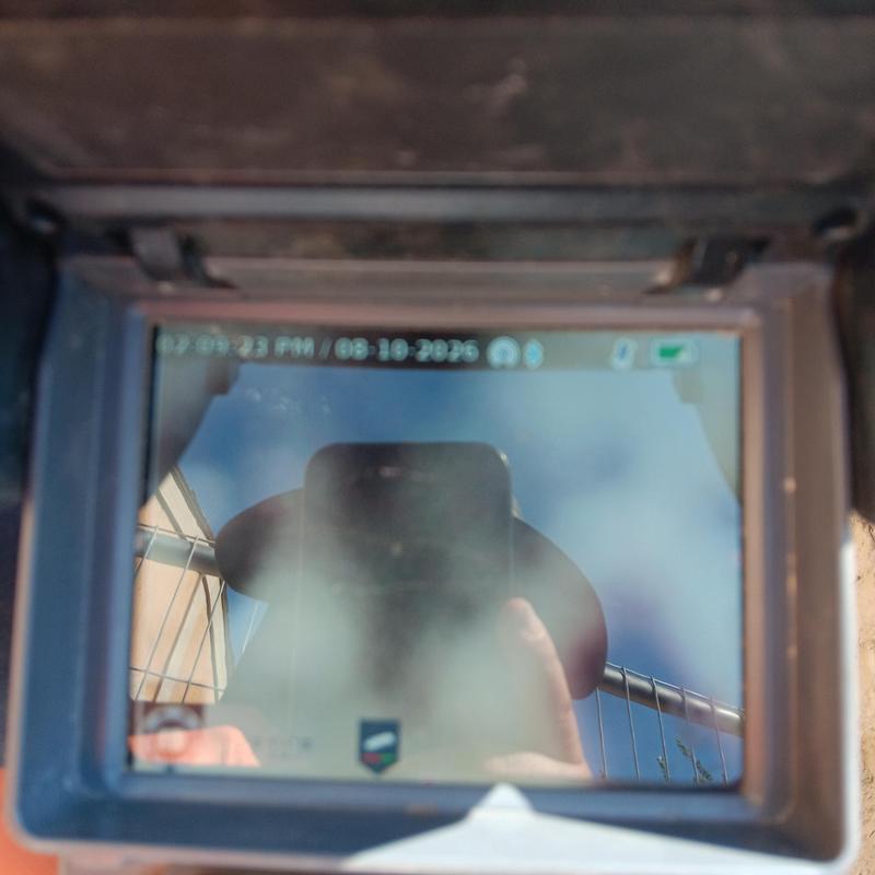 Sewer inspection camera monitor reflecting sky and person Sewer inspection camera monitor reflecting sky and person