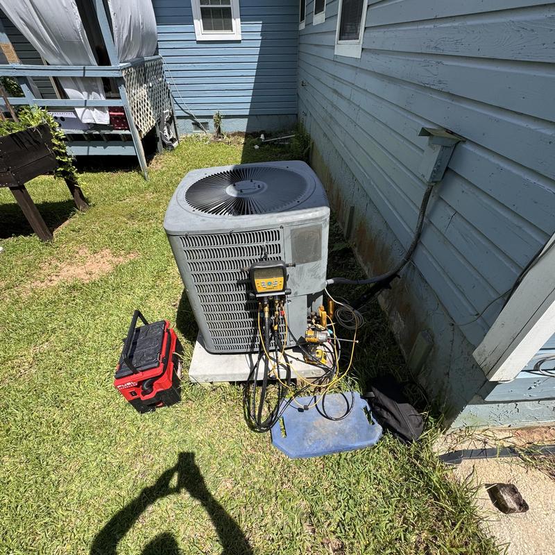 Heat pump outdoor unit with diagnostic gauges connected