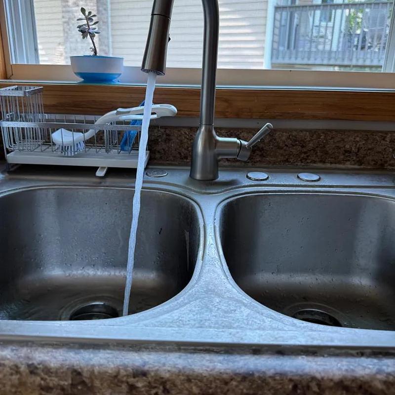 Kitchen sink faucet with running water flowing Kitchen sink faucet with running water flowing