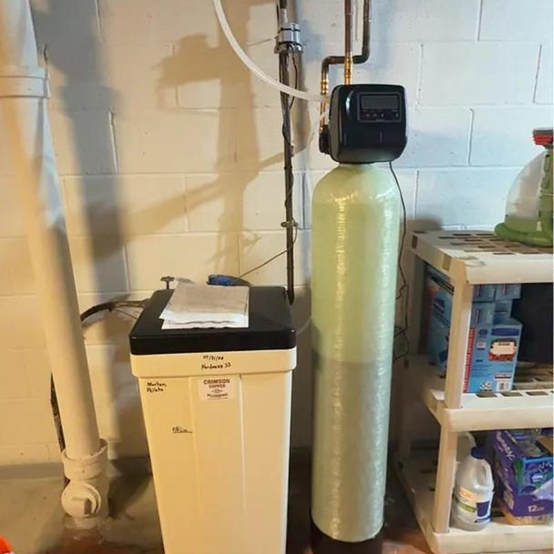 Water softener system installed in basement corner Water softener system installed in basement corner