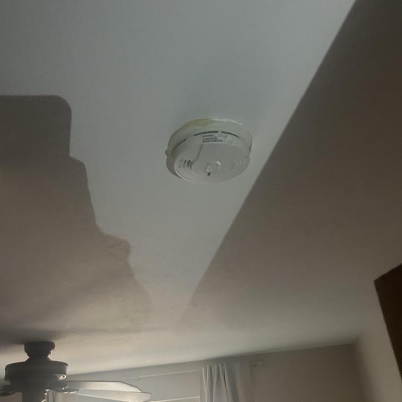 Smoke detector installed on ceiling in home Smoke detector installed on ceiling in home