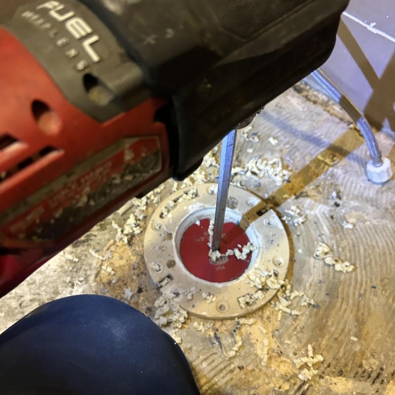 Toilet flange with power tool removing debris Toilet flange with power tool removing debris