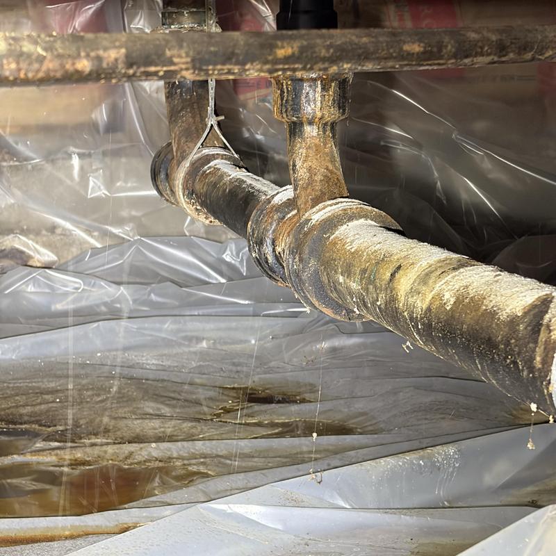 Cast-iron sewer pipe with corrosion and leaks in crawlspace Cast-iron sewer pipe with corrosion and leaks in crawlspace
