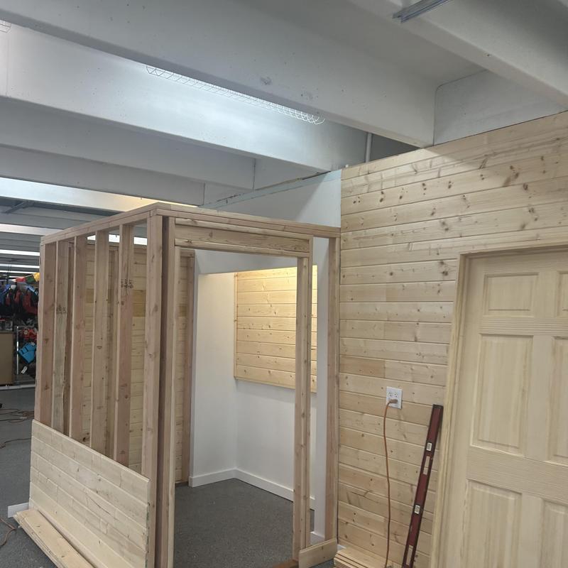 Wood framing with partially installed wood paneling interior Wood framing with partially installed wood paneling interior