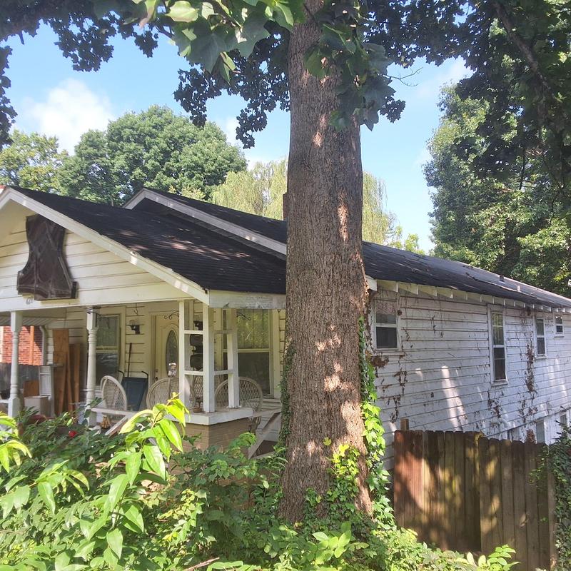 Asphalt shingle roof on residential house with porch