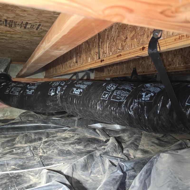 Insulated ductwork in crawl space with metal straps Insulated ductwork in crawl space with metal straps