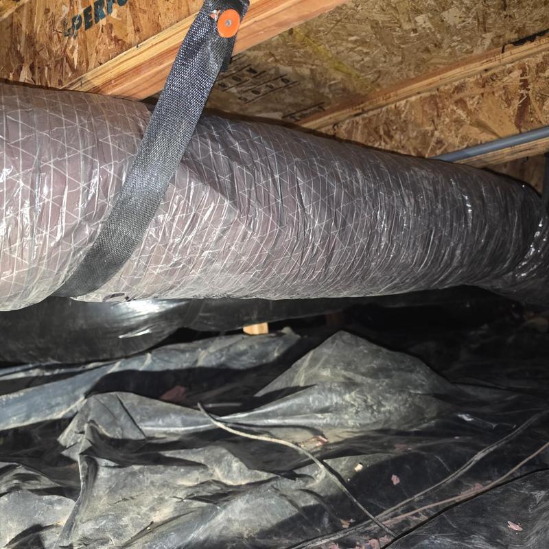 Insulated HVAC duct hanging in crawl space Insulated HVAC duct hanging in crawl space