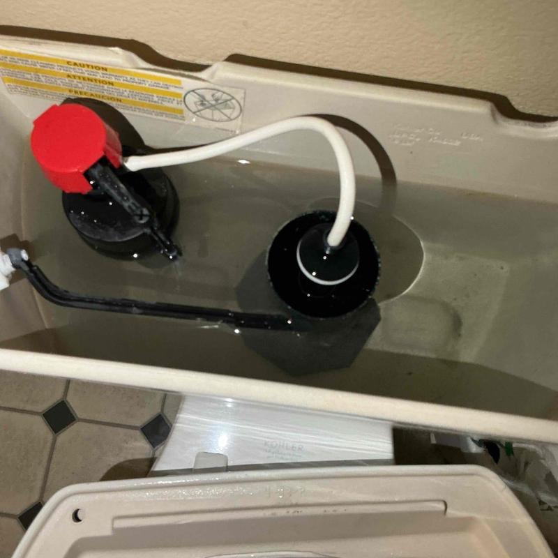 Toilet fill valve and flapper inside tank
