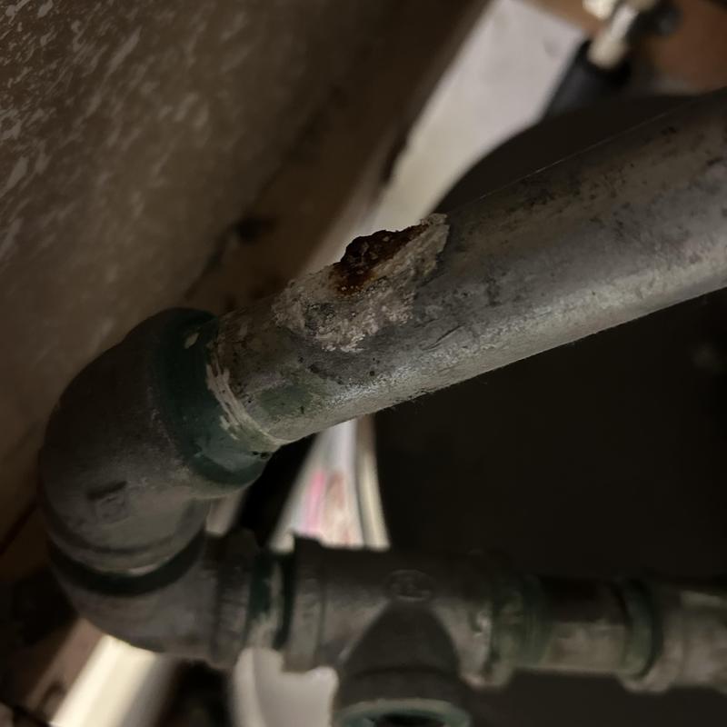 Water heater pipe with corrosion and leak damage Water heater pipe with corrosion and leak damage