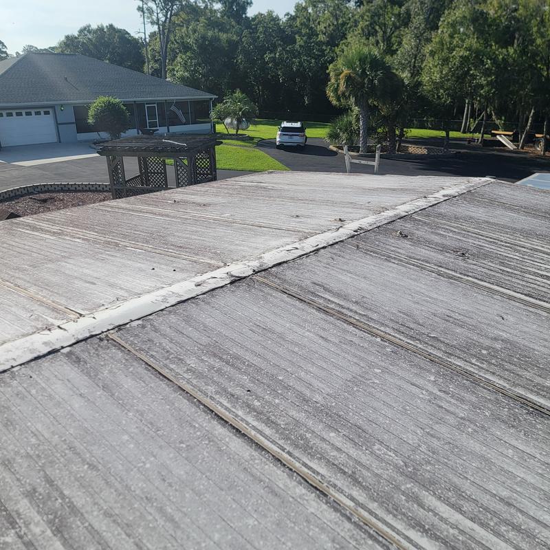 Metal roof panels with sealed ridges on residential property Metal roof panels with sealed ridges on residential property