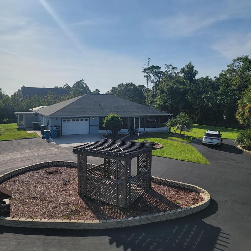 Shingle roof inspection on residential home driveway Shingle roof inspection on residential home driveway