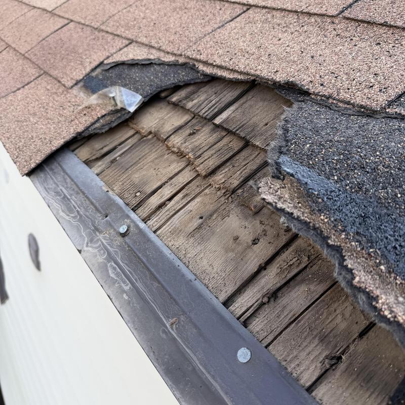 Asphalt shingle roof with wood shake base exposed Asphalt shingle roof with wood shake base exposed