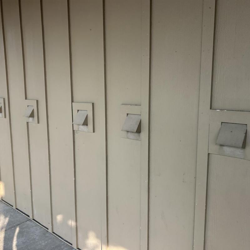 Exterior dryer vent covers on commercial building wall Exterior dryer vent covers on commercial building wall