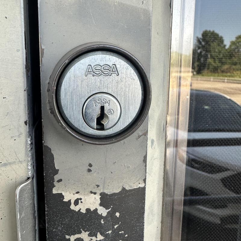 ASSA lock cylinder on commercial door close-up ASSA lock cylinder on commercial door close-up