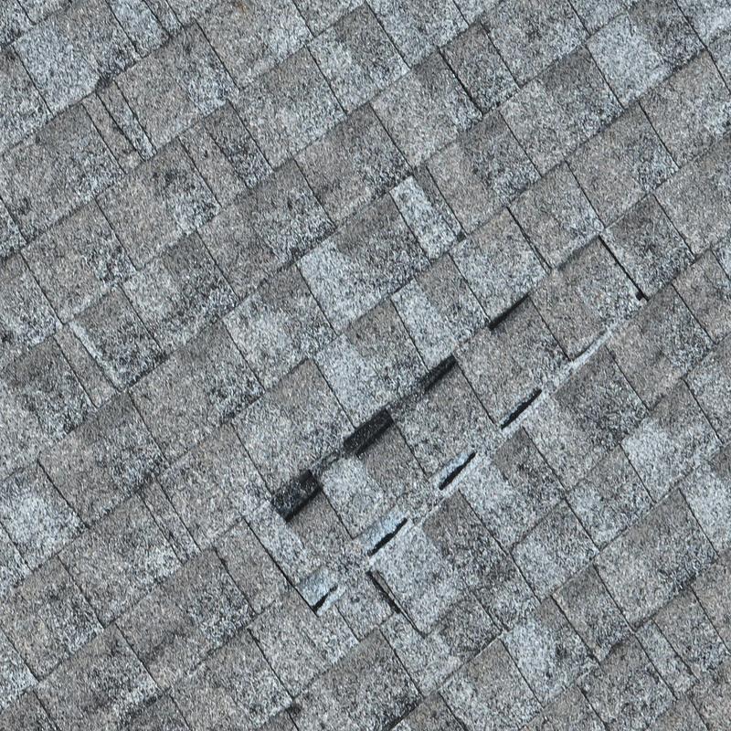 Asphalt shingle roof with visible hail damage and wear