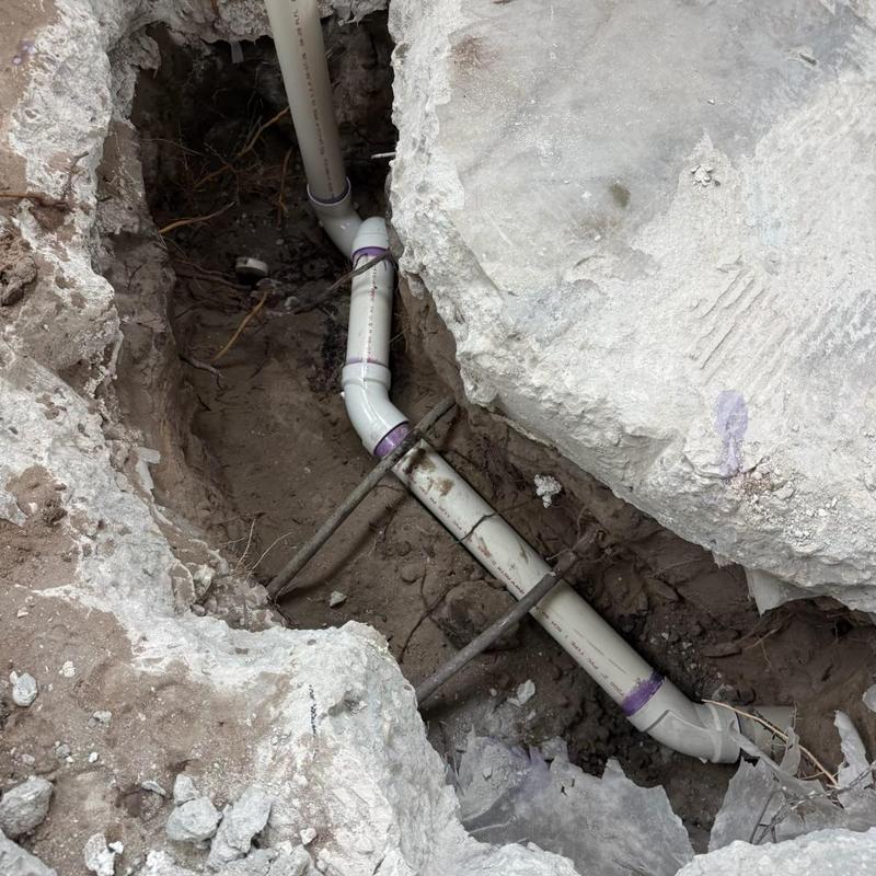 Shower drain plumbing with PVC pipes in concrete slab