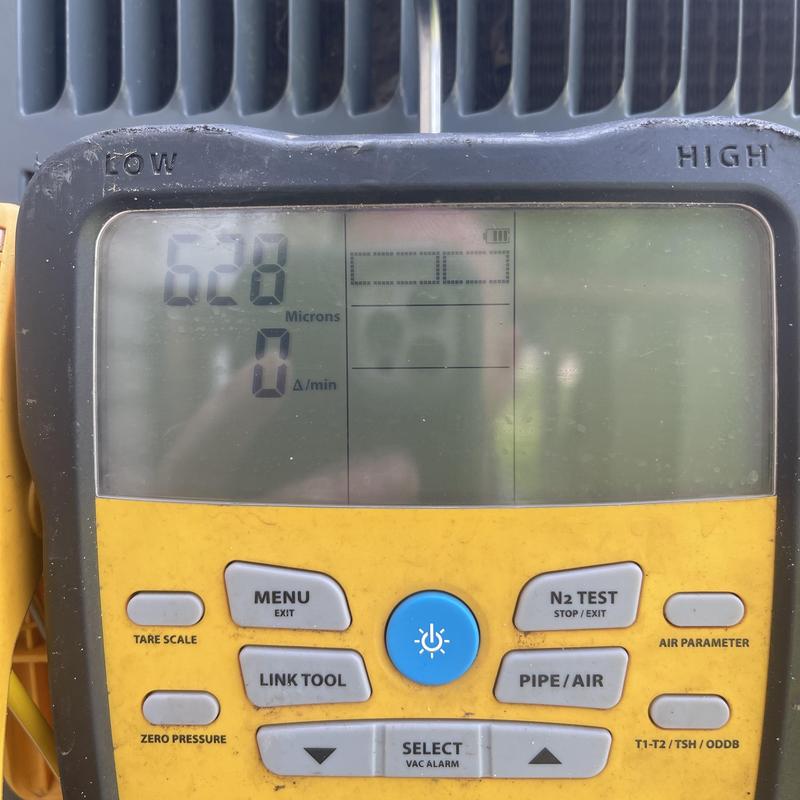 Vacuum gauge showing 628 microns on HVAC system test