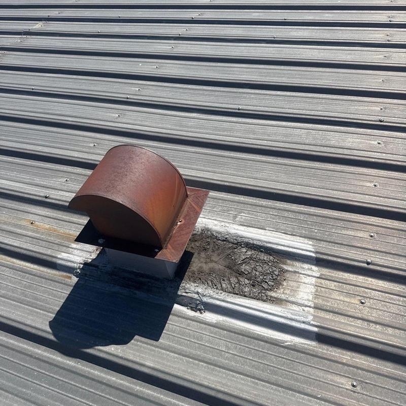 Metal roof vent with rust and sealing damage