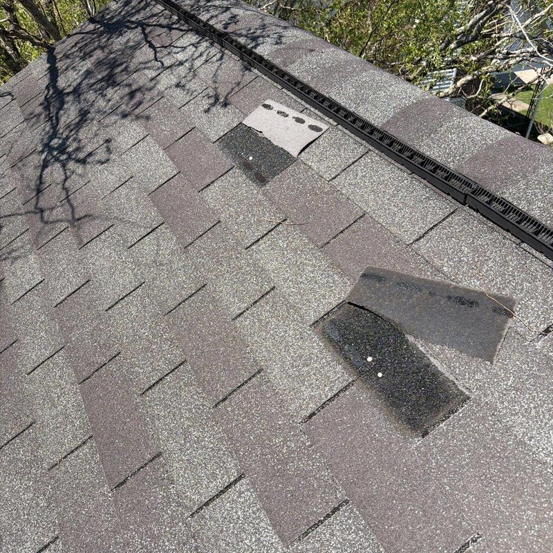 Asphalt roof shingles with hail damage and repairs