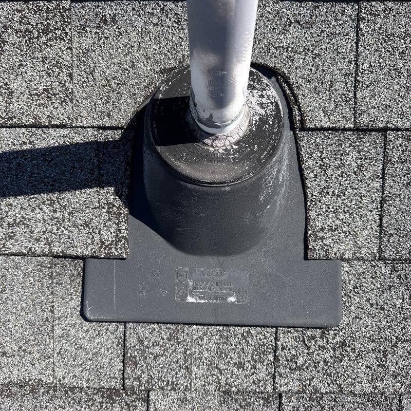 Roof pipe flashing with cracked seal on shingles