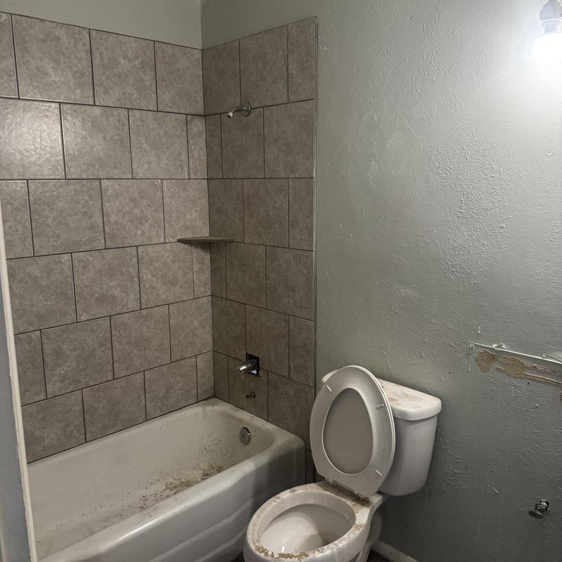 Bathroom tub and toilet rough-in plumbing with tile wall Bathroom tub and toilet rough-in plumbing with tile wall