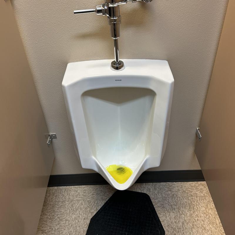 Urinal with yellow descaling solution applied Urinal with yellow descaling solution applied