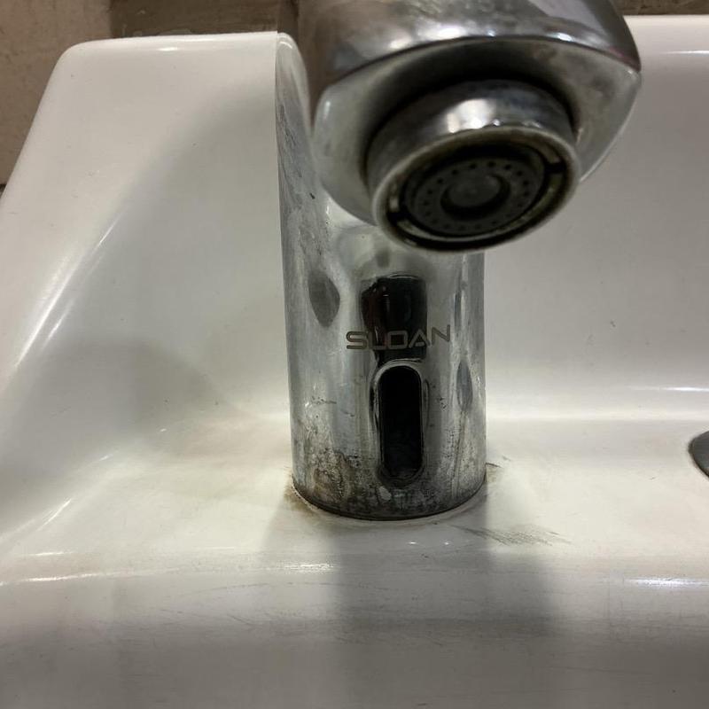 Sloan sensor faucet with grime on men's restroom sink Sloan sensor faucet with grime on men's restroom sink