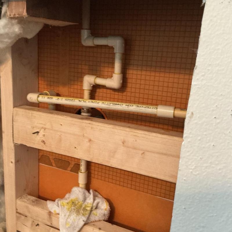 Shower valve and plumbing pipes inside wall cavity Shower valve and plumbing pipes inside wall cavity