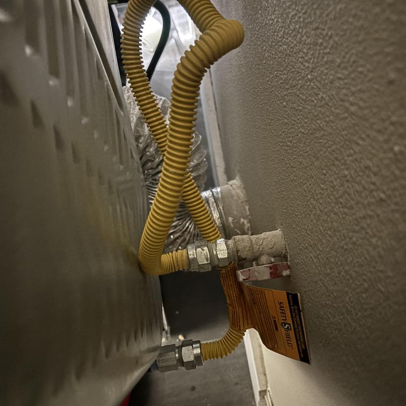Dryer gas line with flexible yellow tubing connection Dryer gas line with flexible yellow tubing connection