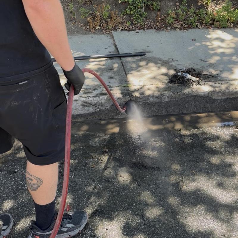 Storm drain hydro jetting removing debris and root balls