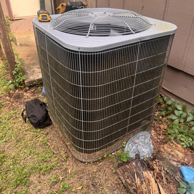 Heat pump condenser coil and fan unit outdoors