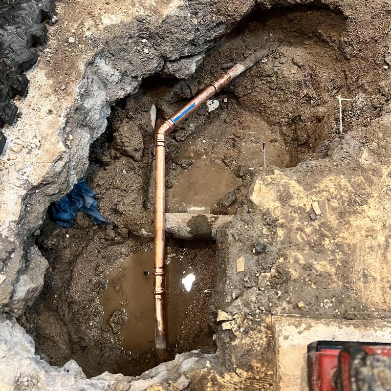 Type L copper pipe exposed in slab excavation