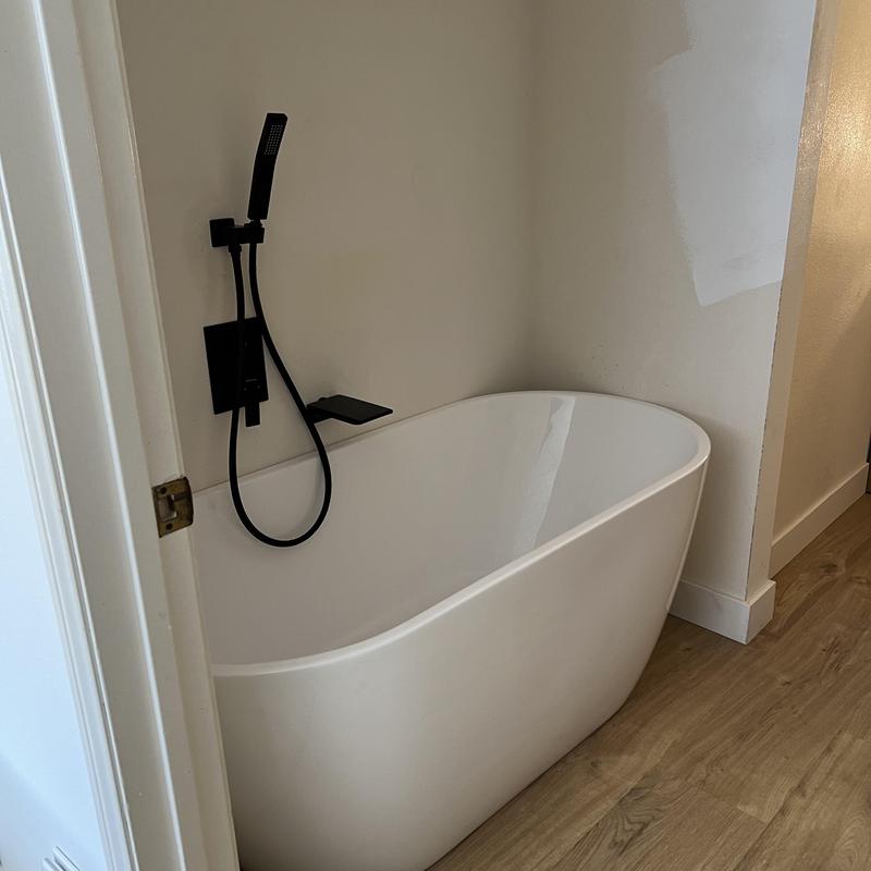Freestanding tub with matte black shower fixtures installation