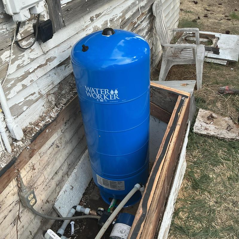 Water pressure tank installation inside well housing